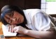 A young woman sleeping on a desk with her eyes closed.