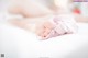 A close up of a baby's feet on a bed.